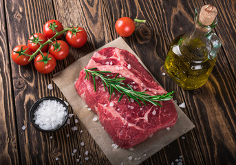 Raw marbled meat steak Ribeye on dark wooden background