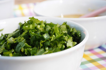 Celery Coriander Cilantro Green Onion sliced mixed in the white cup closeup