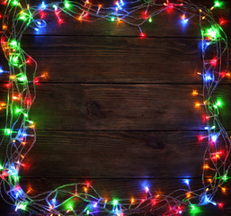 Christmas lights on wooden background