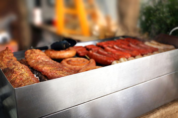 Smoked sausages on grill inside
