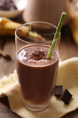 Glass of chocolate milk on table close-up