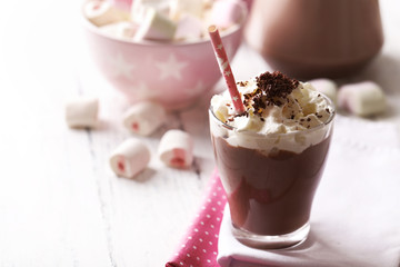 Glass of chocolate milk on table close-up