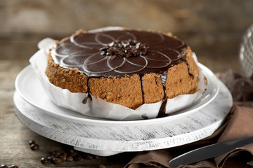 Tasty chocolate cake on wooden background