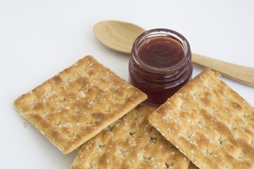 cracker with bottle of jam