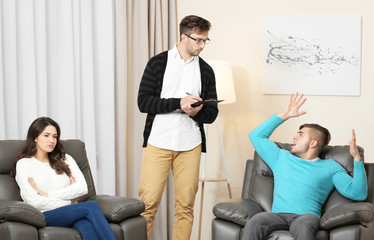 Young couple with problem on reception for family psychologist