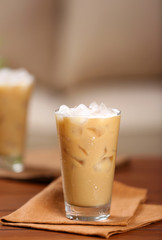 Cups of ice coffee on wooden table