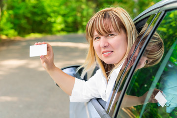 female driver showing a blank card
