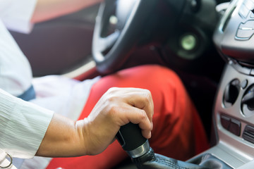 woman's hand speed switches in the vehicle while driving