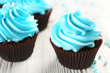 Blue cupcakes on wooden table