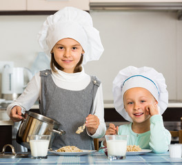 girls having breakfast with porridge