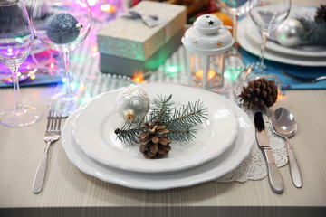 White plates with flatware on a Christmas table