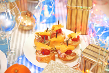 Tasty canapes for festive dinner. Christmas table setting