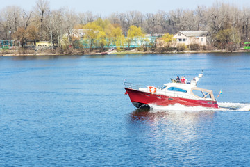 Fototapeta na wymiar Red White boat floating on the river.