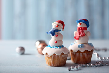 Christmas cupcakes with lights on background