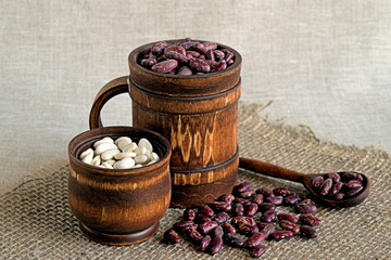  Beans.  Beans red and white in a wooden cookware on a background of burlap.
  