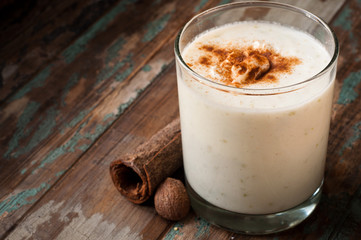 Apple crumble smoothie milkshake topped with cinnamon and nutmeg spices. Served on a rustic wooden table. - obrazy, fototapety, plakaty