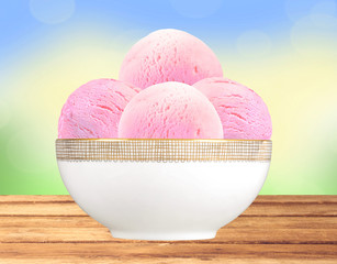 Scoop of fruit ice cream in plate on bright nature background