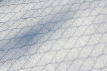 fence shadow on snow