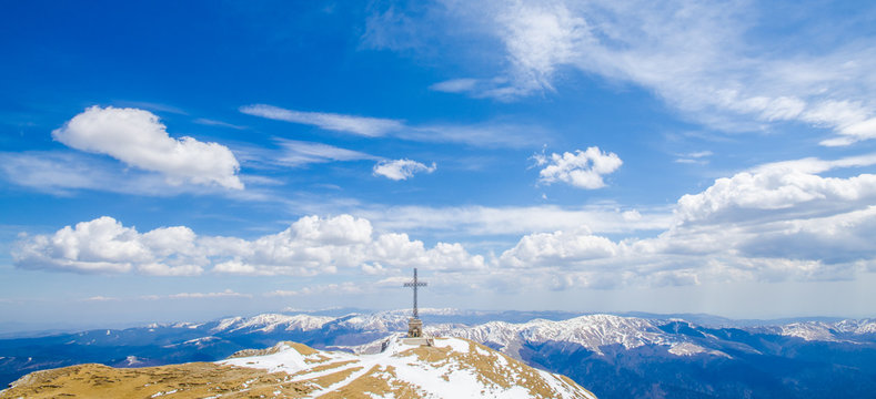 Famous cross on top of Bucegi mountain peaks Omu, in winter season in Romania