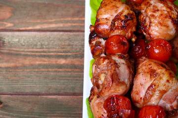 grilled barbecue kebab chicken legs and tomatoes on skewers