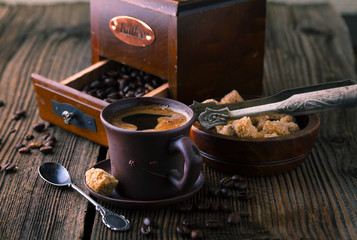Cup of coffee with grains and sugar