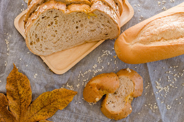 Loaf of sliced bread on wooden background