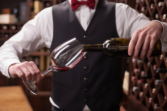 Cheerful Male Waiter Is Serving Alcohol Drink