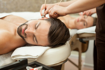 Naklejka premium Pretty married couple is relaxing at beauty salon