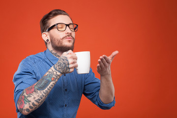 Cute bearded man is smelling hot drink