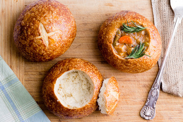 Stages in serving soup in a bread bowl