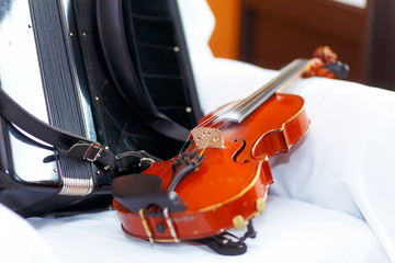 wedding stillife with violin and accordeon on a white cloth.