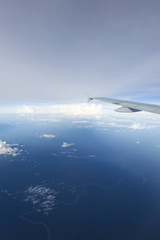 View of jet plane wing with clouds over the Amazonas State, Colo