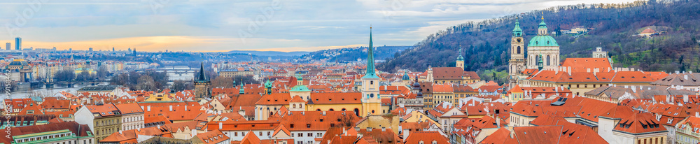 Wall mural Panoramic view onto red roofs of Prague and river Vltava