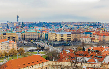 Fototapeta na wymiar View onto red roofs of Prague across Vltava