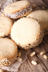 Delicious Alfajores cookies on paper close-up. Vertical, rustic
