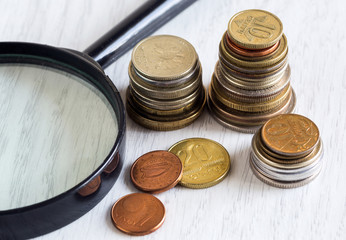  coins and magnifying glass