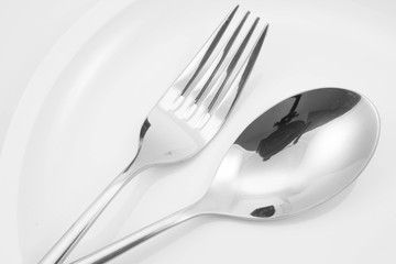 Fork and spoon on a plate with napkin
