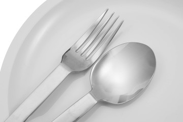 Fork and spoon on a plate with napkin