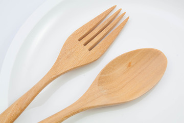 Fork and spoon on a plate with napkin