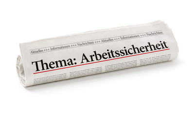 Fototapeta premium Zeitungsrolle mit der Überschrift Arbeitssicherheit