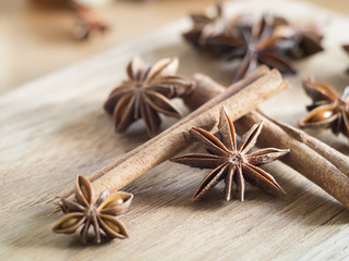Star anise and cinnamon sticks on wooden chopping block