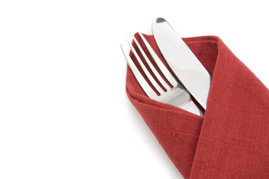 Fork And Knife On Red Napkin Isolated