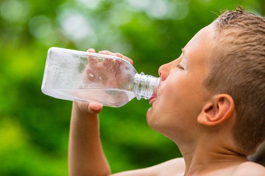 Young boy drinking water from bottle