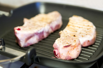 steak with blood on the grill pan