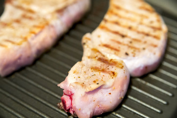 steak with blood on the grill pan