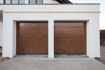 Naklejka premium Double brown garage door in a new house