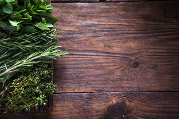 Fototapeta premium Fresh aromatic herbs on wooden background