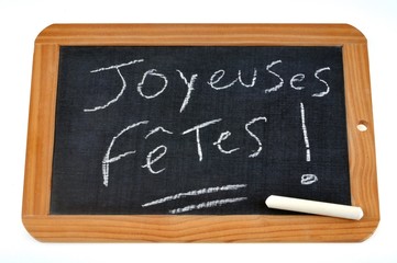 Obraz premium Joyeuses fêtes écrit sur une ardoise 