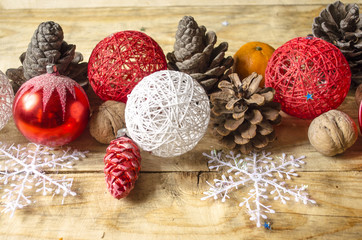 Abstract background with nuts, toys, pine cones on coarse boards
