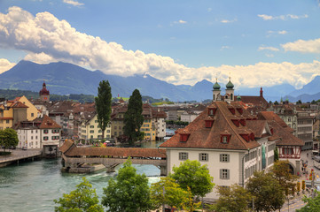 Fototapeta na wymiar HDR image of the view over Luzern, Switserland. The natural museum and spreuerbrucke can be seen and the mountains in the background